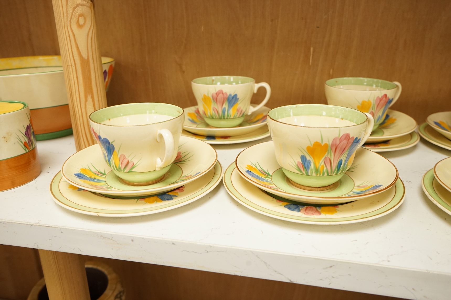 Collection of Clarice Cliff crocus pattern tea wares to include trios, milk jug, and a bowl, largest 22cm in diameter